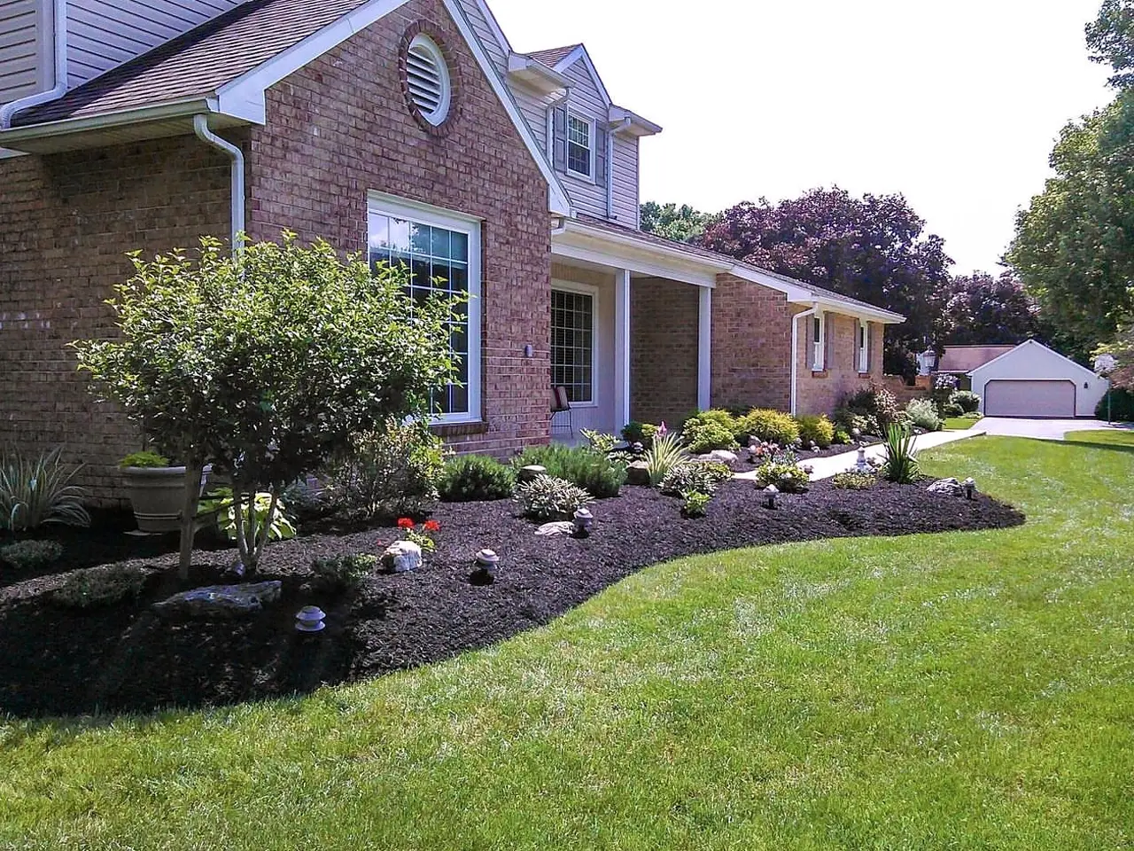 Finished LandMaXx residential landscape with mulched beds and green lawn